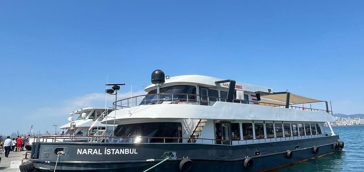 A boat is securely docked at the pier, gently bobbing on the water's surface.
